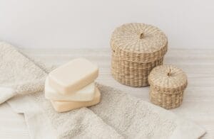close up of soaps towel and wicker basket on wooden surface 23 2147926969