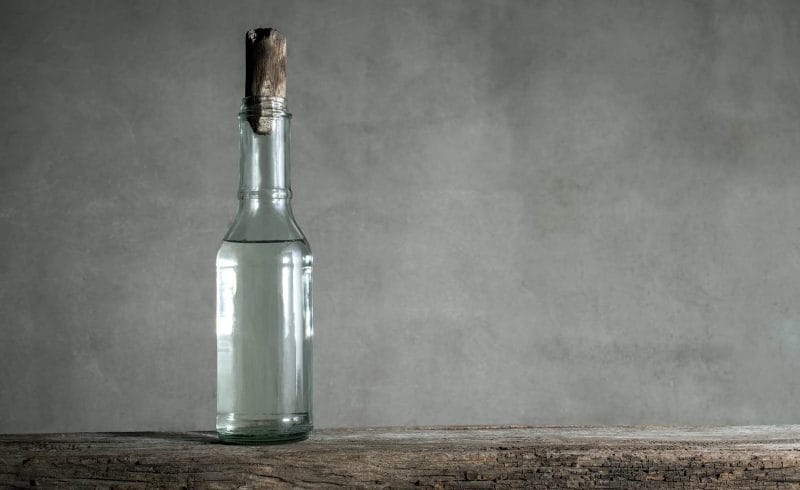 white vinegar bottle on wood table